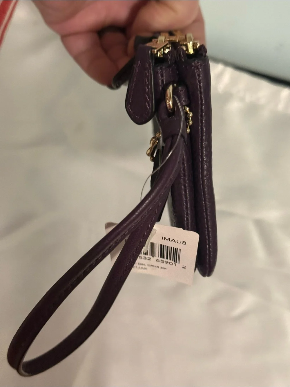 Coach NWT Pebbled Leather Wristlet in Plum w/handtag and two zip compartments.